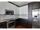 Modern kitchen featuring stainless steel appliances, granite counters, and ample cabinet space at 1 Virginia Ave # 707, Indianapolis, IN 46204