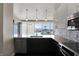 Modern kitchen featuring stainless steel appliances, granite countertops, and three pendant lights at 1 Virginia Ave # 707, Indianapolis, IN 46204