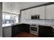 Chic kitchen with stainless steel appliances, stylish lighting, and granite countertops at 1 Virginia Ave # 707, Indianapolis, IN 46204