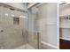 Modern tiled shower featuring a glass enclosure and a built-in niche for toiletries at 1 Virginia Ave # 707, Indianapolis, IN 46204