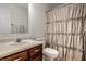 Cozy bathroom featuring a shower with rose-patterned curtain, mirrored vanity, and a neutral color palette at 10220 Tournon Dr, Fishers, IN 46037