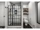 Modern bathroom with a black framed glass shower, stylish hexagon tile floor, and floating shelves for storage at 10220 Tournon Dr, Fishers, IN 46037