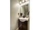 Powder room with vessel sink, modern faucet, wood vanity, and decorative mirror at 10220 Tournon Dr, Fishers, IN 46037