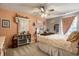 Bright bedroom features stylish decorations, a ceiling fan, large windows and a comfortably-sized bed at 10220 Tournon Dr, Fishers, IN 46037