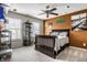 Cozy bedroom with a ceiling fan, display case, and a full sized bed with decorative pillows and natural light at 10220 Tournon Dr, Fishers, IN 46037