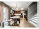 Bright dining area with rustic wooden table, black chairs, and access to the kitchen and outdoor patio at 10220 Tournon Dr, Fishers, IN 46037
