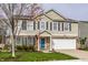Charming two-story home boasts a well-maintained lawn and an attached two-car garage at 10220 Tournon Dr, Fishers, IN 46037