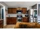 Modern kitchen featuring stainless steel appliances, tile backsplash, and dark wood cabinetry at 10220 Tournon Dr, Fishers, IN 46037