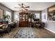 Open living room with hardwood floors, ceiling fan, and a china hutch at 10220 Tournon Dr, Fishers, IN 46037
