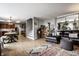 Open-concept living space with hardwood floors, a comfortable leather sectional, and access to the kitchen at 10220 Tournon Dr, Fishers, IN 46037