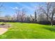 Expansive green backyard showcasing mature trees, providing shade and privacy, enhancing outdoor enjoyment at 10533 Williamsburg Dr, Newburgh, IN 47630