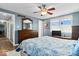 Bedroom with hardwood floors, ceiling fan, large window, and a chest of drawers at 10533 Williamsburg Dr, Newburgh, IN 47630