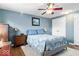 Comfortable bedroom features hardwood floors, ceiling fan, closet, and large window at 10533 Williamsburg Dr, Newburgh, IN 47630