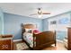 Comfortable bedroom with hardwood floors, ceiling fan, and large windows with natural light at 10533 Williamsburg Dr, Newburgh, IN 47630