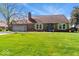 Inviting single-story brick house with a well-maintained lawn and traditional architectural details at 10533 Williamsburg Dr, Newburgh, IN 47630
