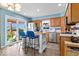 Eat-in kitchen features tile floors, wood cabinets, stainless appliances, and access to the backyard at 10533 Williamsburg Dr, Newburgh, IN 47630