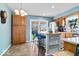 Eat-in kitchen with backyard access, stainless steel appliances, and light blue accent wall at 10533 Williamsburg Dr, Newburgh, IN 47630