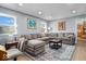 Spacious living room with a large sectional sofa and hardwood floors, perfect for modern living at 10533 Williamsburg Dr, Newburgh, IN 47630