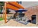 Relaxing patio with a pergola, dining set, grill and chairs perfect for outdoor dining and entertaining at 10533 Williamsburg Dr, Newburgh, IN 47630