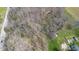 A bird's-eye view of wooded land with a home and shed on the edge of a flooded area at 11015 S State Road 58, Columbus, IN 47201
