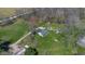 Aerial view of home with long driveway, multiple outbuildings, and surrounded by fields at 11015 S State Road 58, Columbus, IN 47201