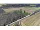 Overhead image of a home surrounded by farmland, featuring a road and a vehicle in transit at 11015 S State Road 58, Columbus, IN 47201