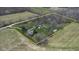 Aerial shot outlining property boundaries with a home, farmland, and wooded area at 11015 S State Road 58, Columbus, IN 47201