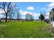 Spacious backyard with green grass and trees at 11015 S State Road 58, Columbus, IN 47201