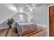 Cozy bedroom featuring a queen bed and sloped walls at 11015 S State Road 58, Columbus, IN 47201