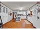 Bright white kitchen featuring updated appliances, ample cabinet space, and hardwood floors at 11015 S State Road 58, Columbus, IN 47201
