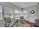 Bright sun room with tiled floor, metal chairs, table, and multiple windows at 11015 S State Road 58, Columbus, IN 47201