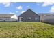 Expansive backyard featuring well-maintained lawn and a view of neighboring homes under a blue sky at 11622 Brookwood Trace Dr, Indianapolis, IN 46229