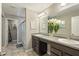 Bright bathroom featuring a double sink vanity, a large mirror, and a glass-enclosed shower at 11622 Brookwood Trace Dr, Indianapolis, IN 46229