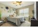 Cozy bedroom with a comfortable bed, decorative wall art, and a ceiling fan at 11622 Brookwood Trace Dr, Indianapolis, IN 46229