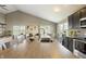 Open kitchen layout with breakfast bar, stainless steel sink, and seamless flow into the living area at 11622 Brookwood Trace Dr, Indianapolis, IN 46229