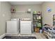Functional laundry room with washer, dryer, shelving, and storage solutions for cleaning supplies and essentials at 11622 Brookwood Trace Dr, Indianapolis, IN 46229
