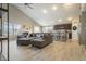 Open-concept living room with vaulted ceilings and hardwood floors, seamlessly flowing into the kitchen at 11622 Brookwood Trace Dr, Indianapolis, IN 46229