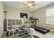 Versatile office space with desk, treadmill, shelving, and natural light for a productive work environment at 11622 Brookwood Trace Dr, Indianapolis, IN 46229