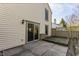 A patio area with sliding glass doors leading into the home and a wooden fence at 11674 Buttonwood Dr, Carmel, IN 46033