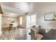 Open concept dining area with wood floors, natural light, and seating for six at 11674 Buttonwood Dr, Carmel, IN 46033