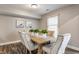 Bright dining area with a wooden table, upholstered chairs, and decor at 11674 Buttonwood Dr, Carmel, IN 46033