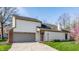 Attractive 2-story home featuring an attached garage and a well-manicured lawn at 11674 Buttonwood Dr, Carmel, IN 46033
