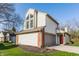 Charming two-story home with a red front door, attached garage and well-maintained lawn at 11674 Buttonwood Dr, Carmel, IN 46033