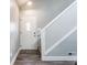 Inviting foyer with a clean white door, hardwood floors, and stylish staircase at 11674 Buttonwood Dr, Carmel, IN 46033