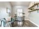 Cozy home office with a comfortable chair, natural light, and wood floating shelves at 11674 Buttonwood Dr, Carmel, IN 46033