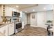 Well-lit kitchen with stainless steel appliances, granite countertops, and ample cabinet space at 11674 Buttonwood Dr, Carmel, IN 46033