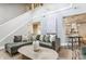 Bright living room featuring a plush sectional sofa, hardwood floors, and open floor plan at 11674 Buttonwood Dr, Carmel, IN 46033