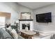 Inviting living room with a painted brick fireplace, modern decor, and comfortable seating at 11674 Buttonwood Dr, Carmel, IN 46033