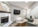 Cozy living room featuring a white brick fireplace, skylight, and a comfortable sectional sofa at 11674 Buttonwood Dr, Carmel, IN 46033