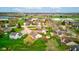 A bird's eye view presents properties with blooming trees and trimmed lawns, conveniently located near local resources at 118 Presidential Ct, Greenfield, IN 46140